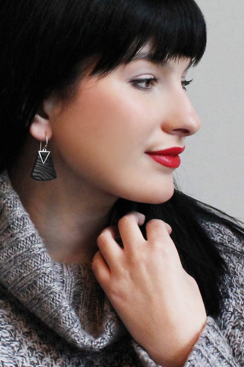 black-haired fashion model wearing Bijoux Pépine's Nil earrings in black