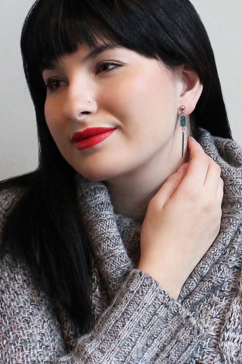 black-haired model wearing Bijoux Pépine’s handmade Nova stud earrings in forest green