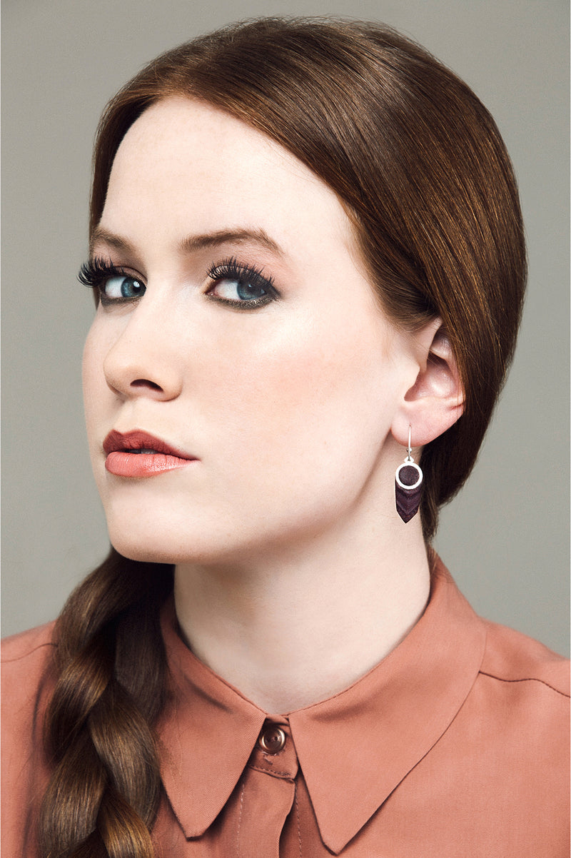 fashion model wearing jewelry designer Bijoux Pépine's handmade Panache earrings in burgundy red