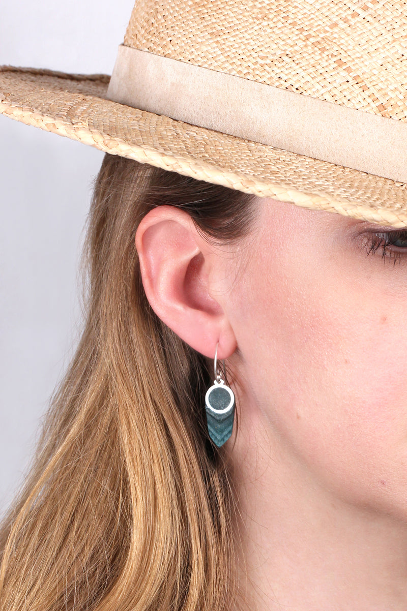 model wearing Panache earrings handmade with forest green resin and hypoallergenic stainless steel