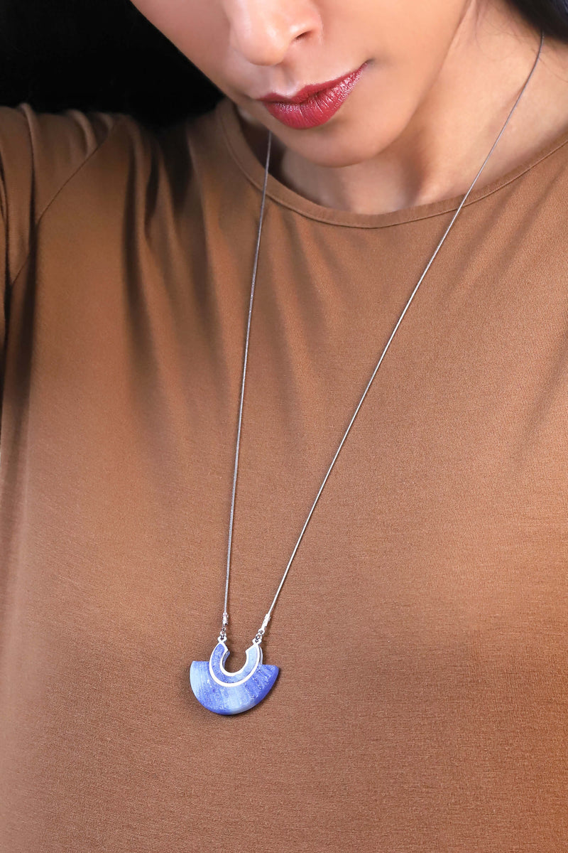 Model woman wears Aurore, coral indigo blue resin and hypoallergenic stainless steel pendant necklace handmade