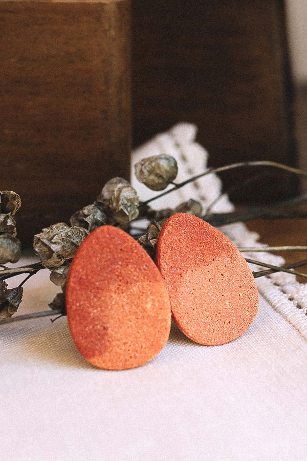 contemporary fashion still life of Bijoux Pépine's Sangatte studs in coral red