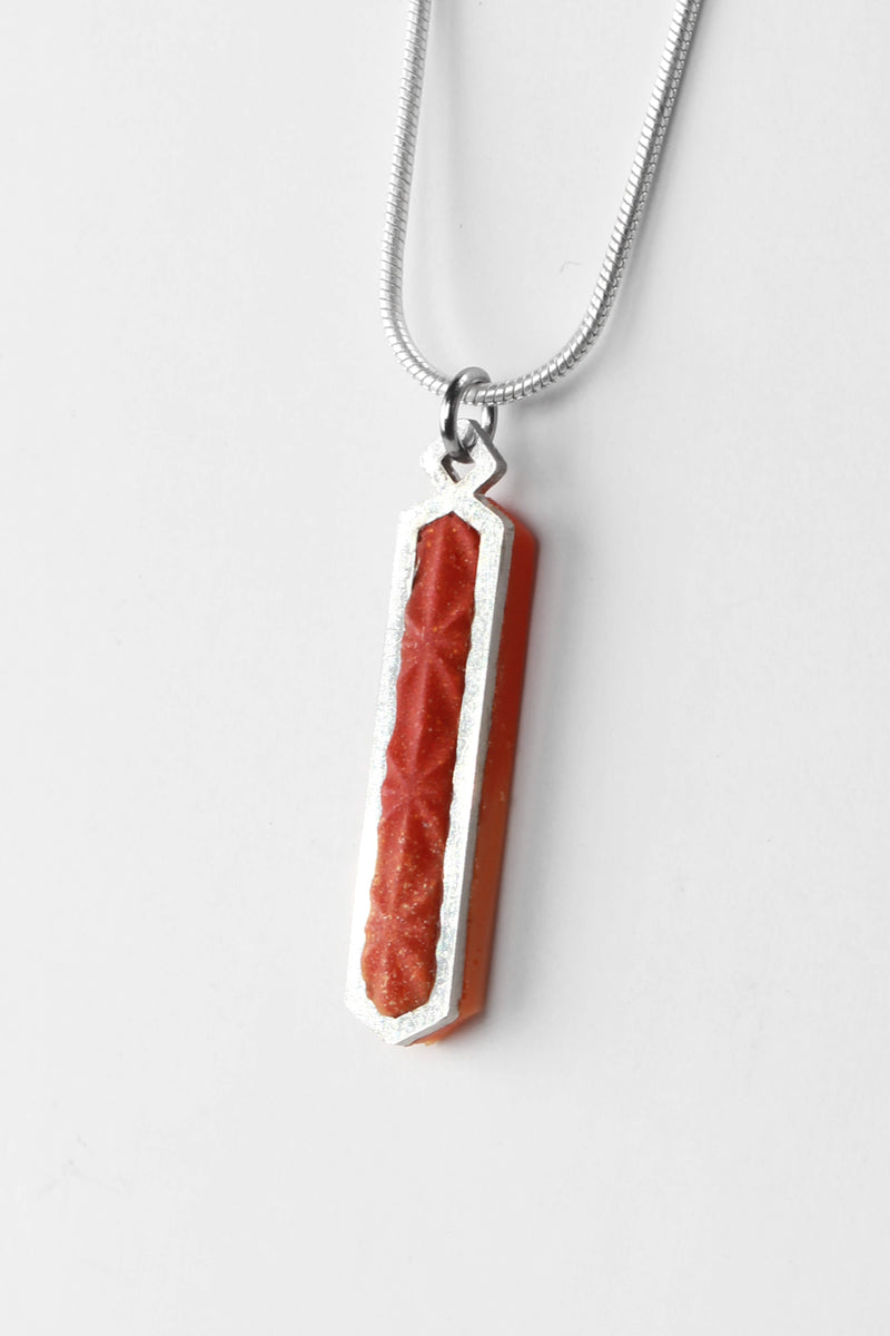 Solstice adjustable length necklace in red color sustainable resin and hypoallergenic stainless steel chain, handmade process