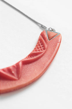 close-up of Couronne, handmade necklace in coral red resin and hypoallergenic stainless steel