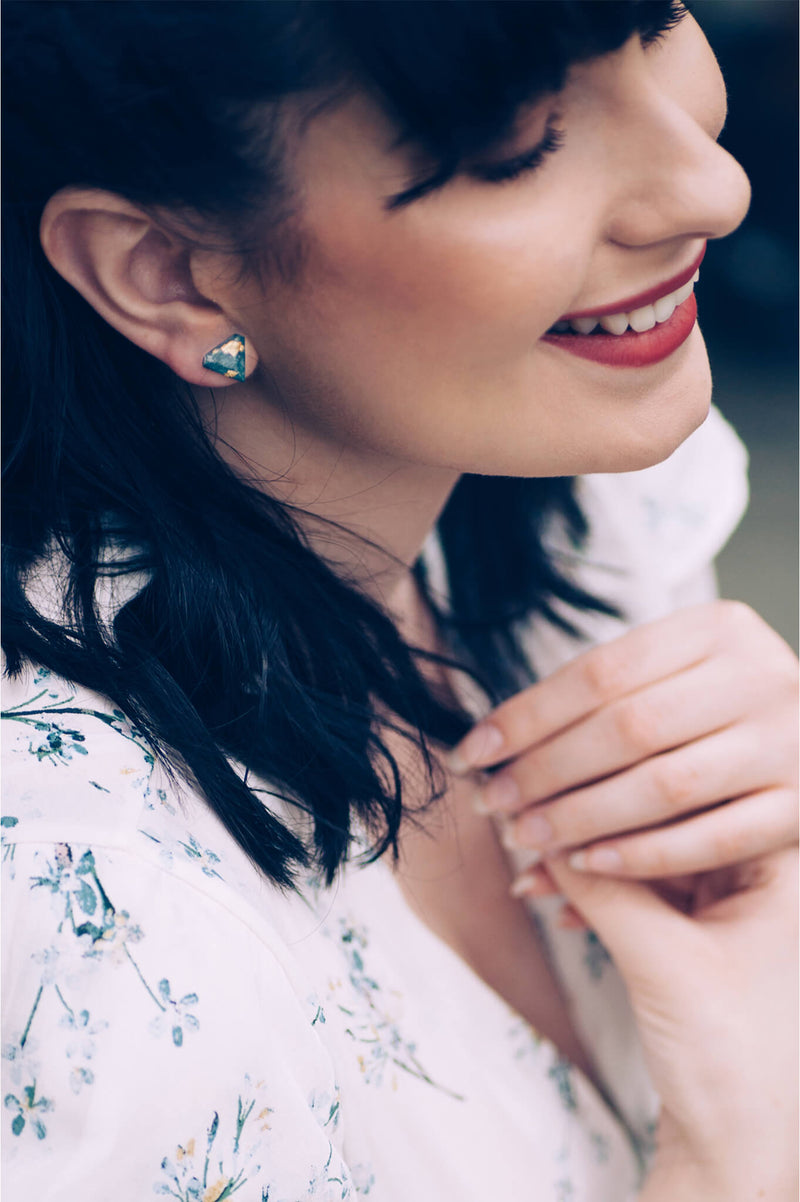 fashion model wearing Bijoux Pépine's mint green resin and gold leaf Diamant earrings