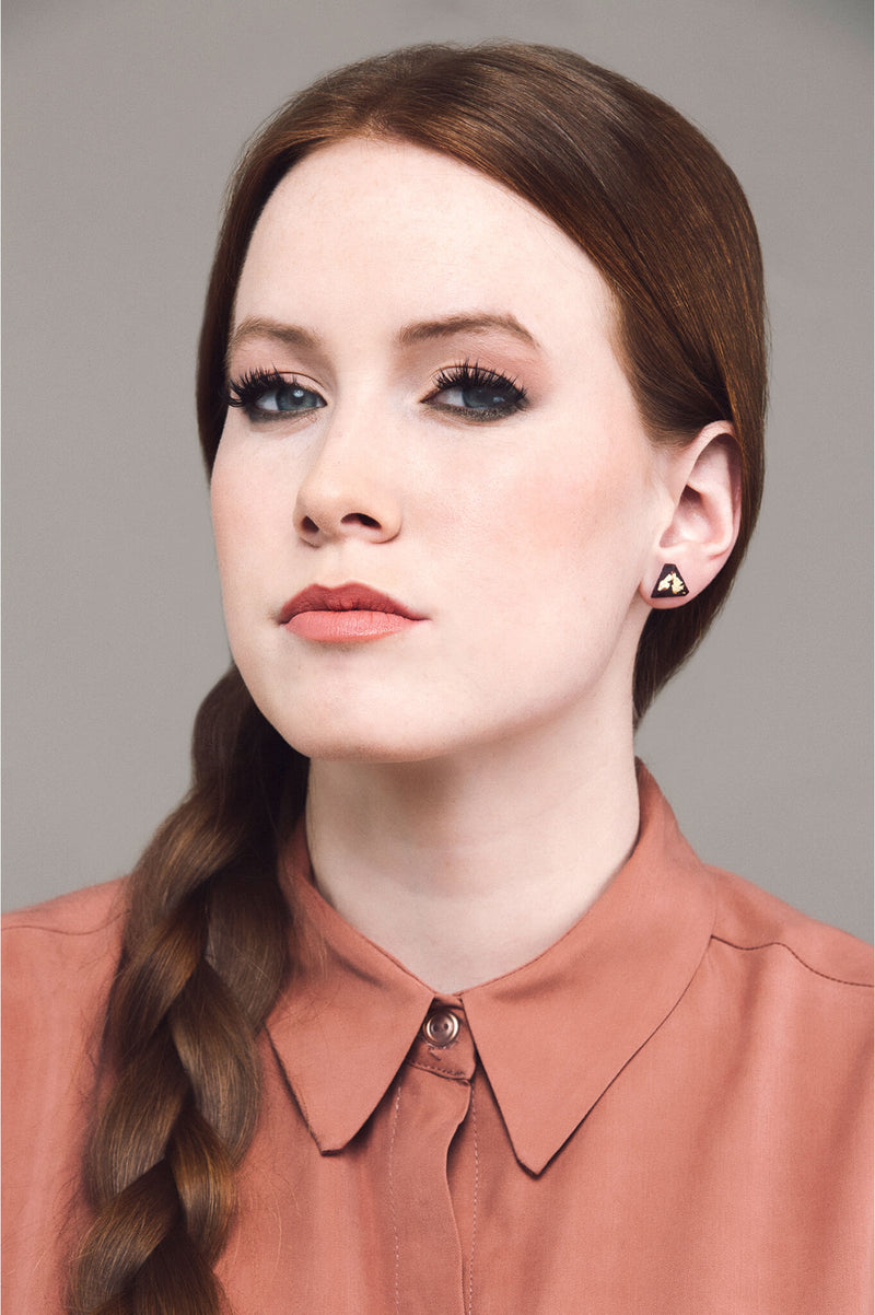 model wearing Bijoux Pépine's burgundy red resin and gold leaf Diamant earrings
