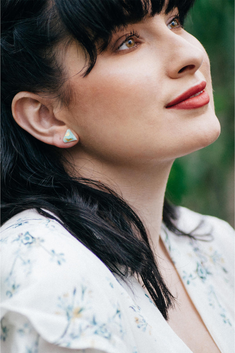model wearing Montreal designer Bijoux Pépine's white resin and gold leaf Diamant earrings
