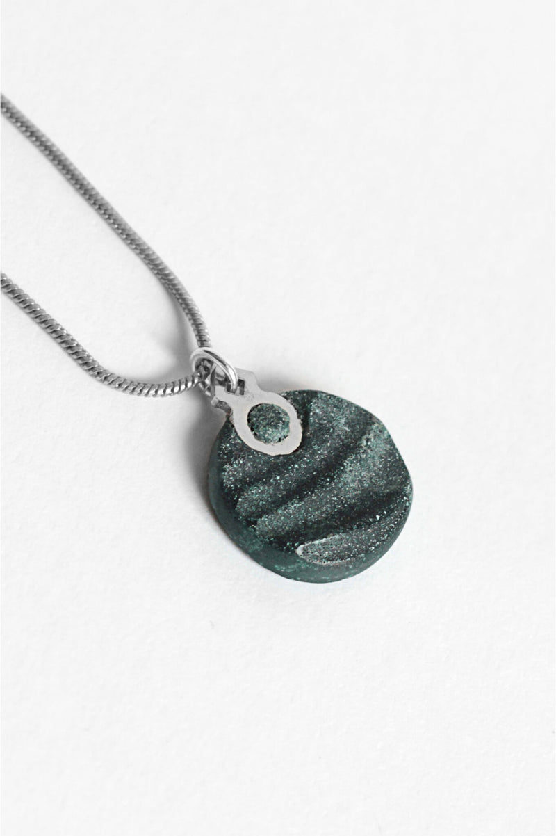 close-up of Dune, handmade necklace in two-toned forest green resin and hypoallergenic stainless steel