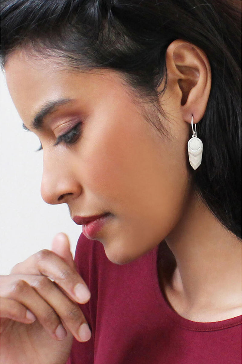 model wearing Panache earrings handmade with beige resin and hypoallergenic stainless steel