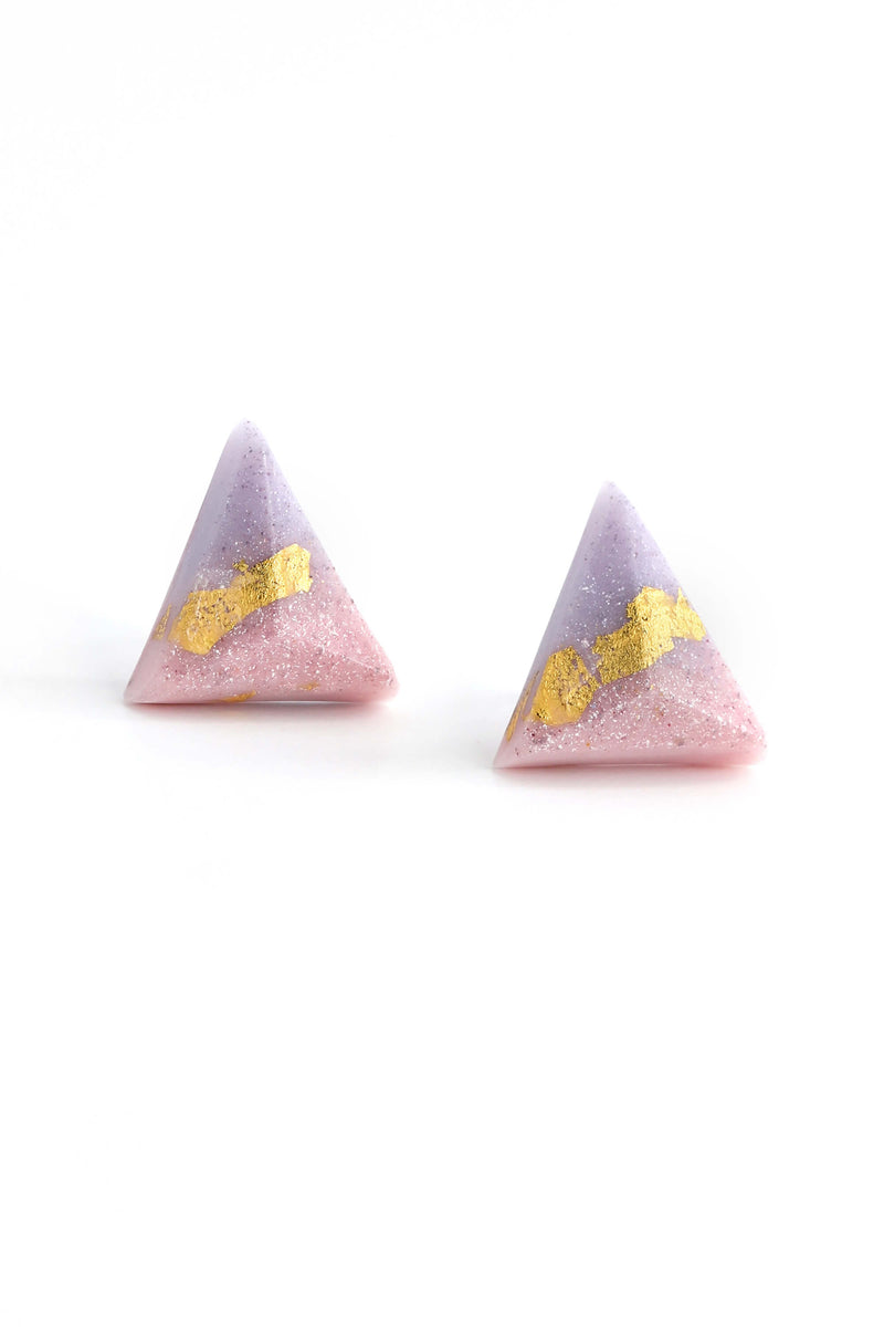 fashion model female wearing Bijoux Pépine's hypoallergenic Pyramide studs in lilac and pastel pink with sustainable resin and 24 carats gold leaf