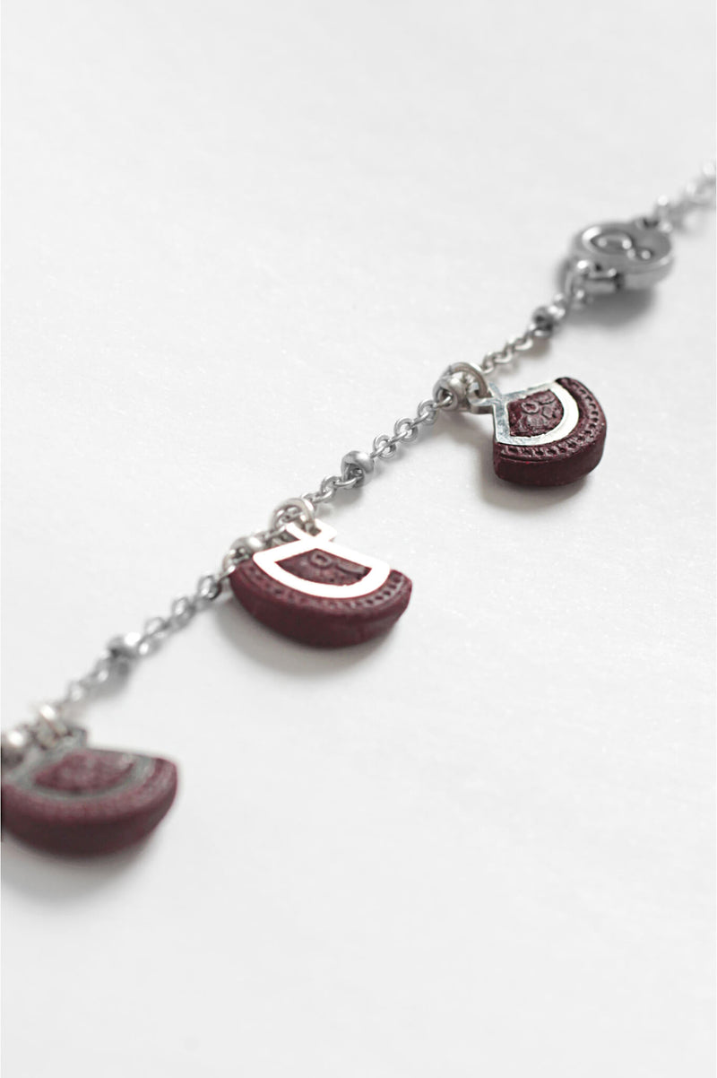 St-Jacques, luxury charms bracelet handmade in Canada with hypoallergenic stainless steel and burgundy red resin