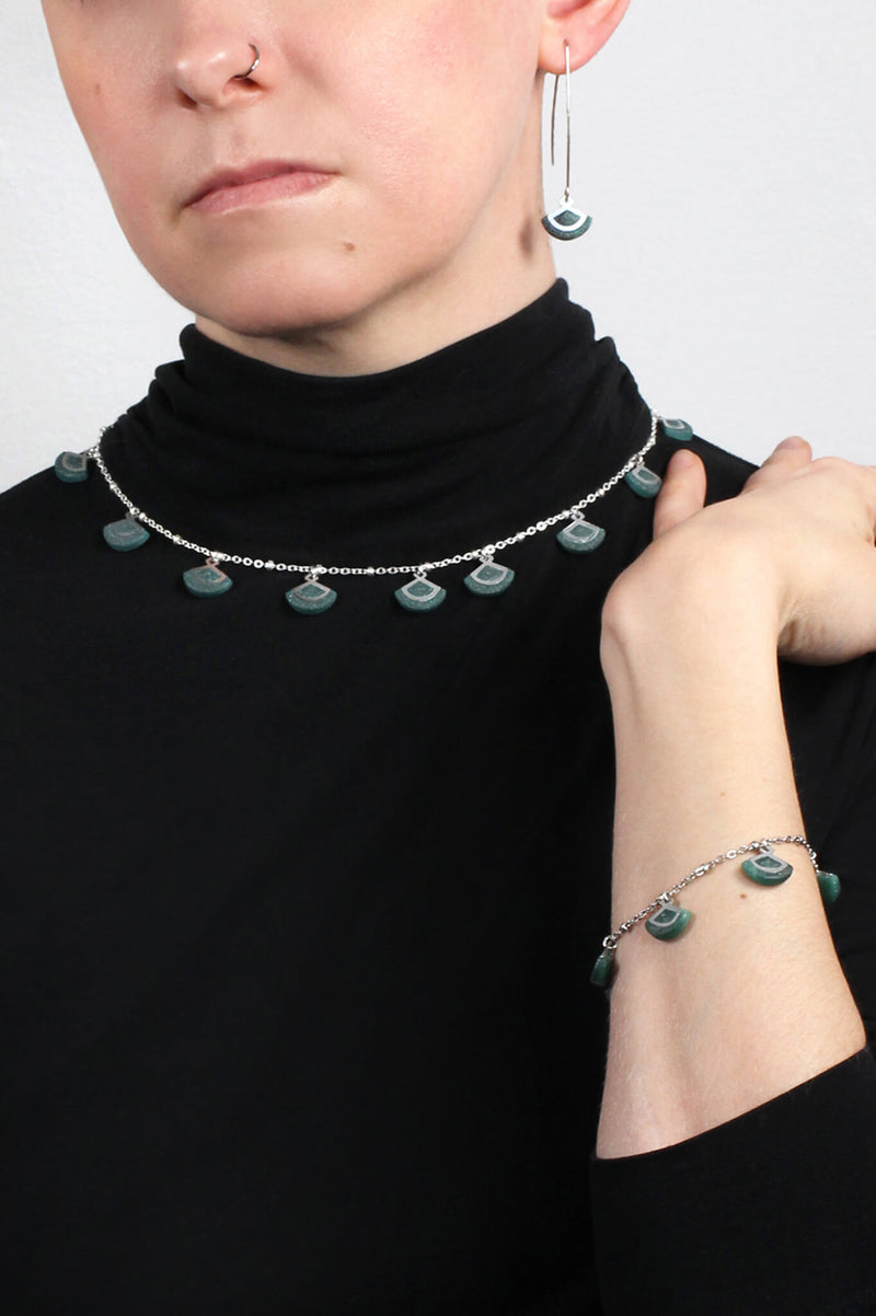 model wearing St-Jacques forest green necklace and matching bracelet and earrings