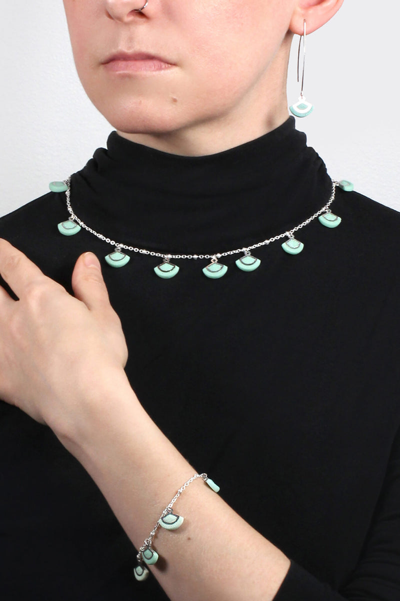 model wearing St-Jacques mint green necklace and matching bracelet and earrings
