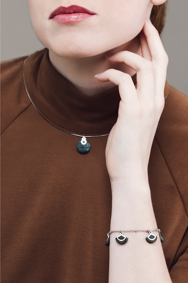 female model wearing St-Jacques luxury bracelet in forest green, handmade by Bijoux Pépine
